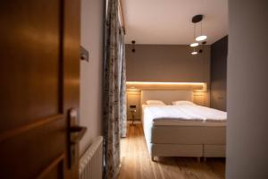 Postel nebo postele na pokoji v ubytování Arbostora Charme Hotel