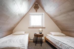 
Łóżko lub łóżka w pokoju w obiekcie Apartamenty Butorowy Zakopane
