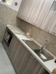 a kitchen with a sink and a counter top at Casa Dolce Franca in Alghero +44 photos