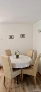 a table with two chairs and a white table cloth on it at Apartment Mira in Baška