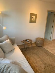 a living room with a couch and a table at Es Cucó in Cala Galdana