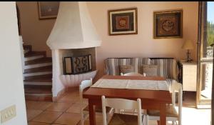 a dining room with a table and a fireplace at BELVEDERE in La Maddalena