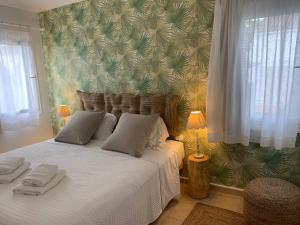 a bedroom with a bed with two towels on it at Es Cucó in Cala Galdana