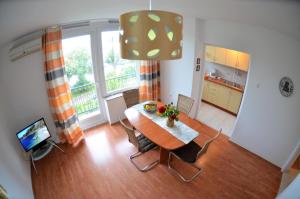 a kitchen and dining room with a table and chairs at Apartment Zic in Krk