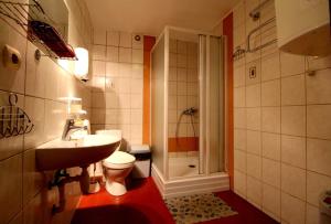 a bathroom with a toilet and a sink and a shower at Pie Jāņa Brāļa in Liepāja