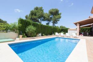 een zwembad met stoelen in de tuin bij Casa Mar Blau - mediterranean house in Puigderrós