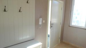 a bathroom with a shower and a phone on the wall at Captain's Island Deluxe in Chernomorets