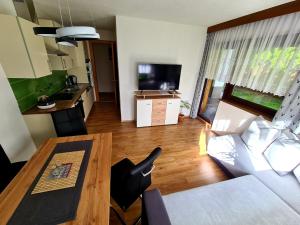 a living room with a couch and a table and a kitchen at ALPTyrol in Rifenal