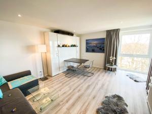 a living room with a couch and a table at WellenRausch Living "Nock" in Travemünde