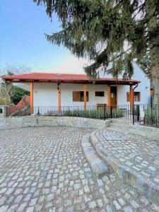 a white building with a red roof at Döme's Point in Leányfalu