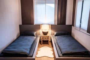 Habitación pequeña con 2 camas y lámpara en Apartment Schifta, en Chienes