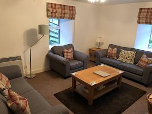 a living room with two couches and a coffee table at Keeper's Cottage in Lochgilphead