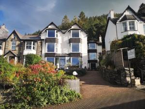 a large white house with flowers in front of it at Aberconwy House B&B in Betws-y-coed