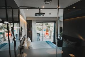 a bedroom with a bed and a large glass window at H Boutique Peña Parda in La Herradura