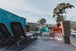 a group of chairs sitting on top of a balcony at H Boutique Peña Parda in La Herradura