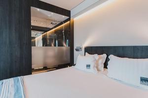 a bedroom with a large bed with white sheets and pillows at H Boutique Peña Parda in La Herradura