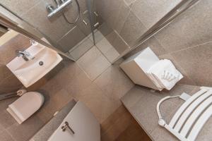 an overhead view of a bathroom with a toilet and sink at Cuprum Poilsis in Palanga +23 photos