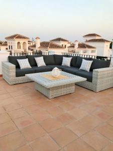 a black couch sitting on top of a patio at Villa Pagel - A Murcia Holiday Rentals Property in Roldán