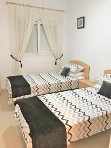 two beds sitting next to each other in a bedroom at Villa Pagel - A Murcia Holiday Rentals Property in Roldán