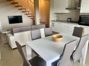 a dining room with a white table and chairs at Casa Jonorunn in Nibbiaia