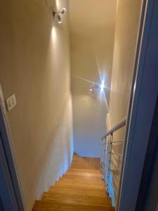 a hallway with a staircase with a light on the wall at Casa Jonorunn in Nibbiaia