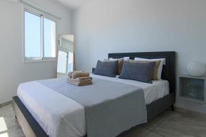 a bedroom with a large bed with blue pillows at Phaedrus Living: Seaside Luxury Flat Lighthouse 74 in Paphos