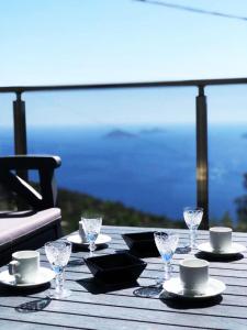a table with plates and glasses on a table with a view at Aren Guest House in Kalkan in Kaş