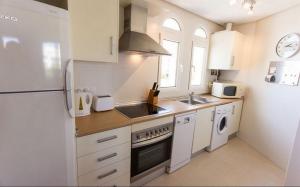 a kitchen with a refrigerator and a sink at Casa Jurel - A Murcia Holiday Rentals Property in Roldán +3 photos