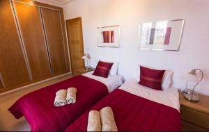 two beds sitting next to each other in a bedroom at Casa Jurel - A Murcia Holiday Rentals Property in Roldán