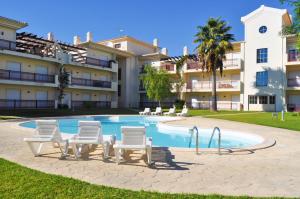 a swimming pool in front of a large building at Bogart at Casablanca by OCvillas in Albufeira
