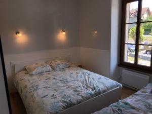 een kleine slaapkamer met een bed en een raam bij Chambres individuelles avec partie commune ou logement entier si disponible Via Rhôna in Vulbens