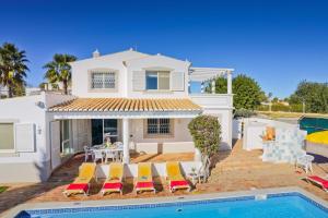 a villa with a swimming pool and a house at Villa Flor by Villa Plus in Guia