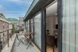 einen Balkon mit Glastüren sowie einem Tisch und Stühlen in der Unterkunft Taksim Peri Suite in Istanbul