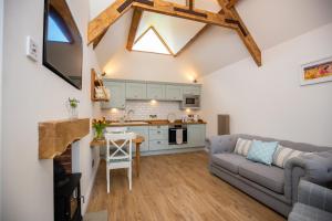a living room with a couch and a table at Exclusive Holiday Accommodation - Bancoft Cottage in Bedale