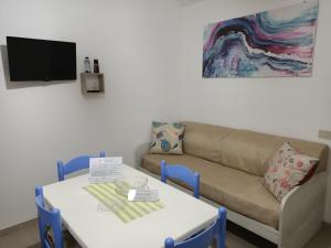 a living room with a table and a couch at Case Costa Degli Dei in Santa Domenica