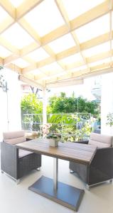 a large table and chairs in a room with a ceiling at Villa Angelus in Nice