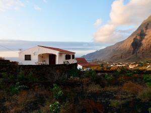 a house on a hill with a mountain in the background at Los Canteros de Belgara - Atlantic View Retreat in Frontera