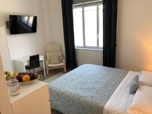 a bedroom with a bed and a bowl of fruit on a table at Nonna Febronia in Patti