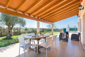 an outdoor patio with a table and chairs at YourHouse Son Gallina quiet, private villa in the north of Mallorca in Sa Pobla