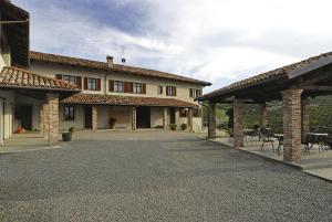 a large house with two pavilions and a patio at Agriturismo Rio Sordo in Barbaresco