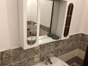 a bathroom with a sink and a mirror at Nonna Febronia in Patti