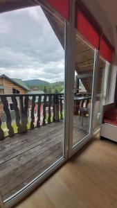a sliding glass door with a view of a balcony at Лиза in Slavske