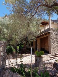 a house with a fence in front of it at YourHouse Cas Sito in Cala Tuent