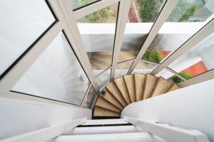 a spiral staircase in a building with windows at Avenue Palm Eforie in Eforie Nord