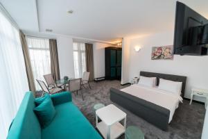 a living room with a bed and a couch at Avenue Palm on the Beach - Avenue Hotels in Eforie Nord