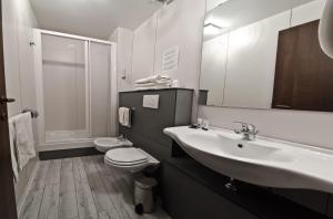 a bathroom with a sink and a toilet and a mirror at Londrino Sanremo in Sanremo