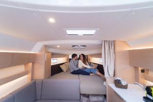 a man and woman sitting on a couch in a rv at GreRos Yacht by ClaPa H.&G Group in Naples
