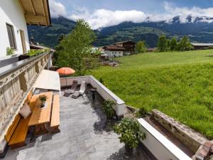 um pátio com uma mesa e cadeiras numa varanda em Appart Klocker em Kaltenbach