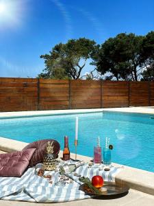 a table with food and drinks next to a swimming pool at Apartments Borghetto in Vinkuran