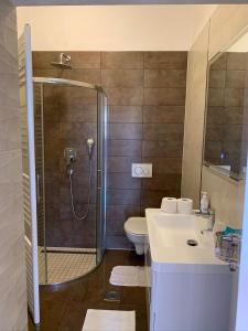 a bathroom with a shower and a toilet and a sink at Apartments Ban in Novi Vinodolski